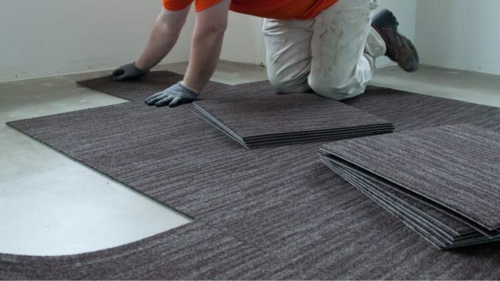 Man Replacing Carpet Tiles With Hand in Dubai