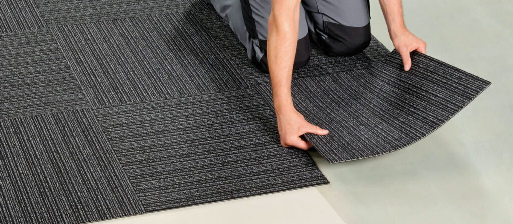 a man installing carpet tiles